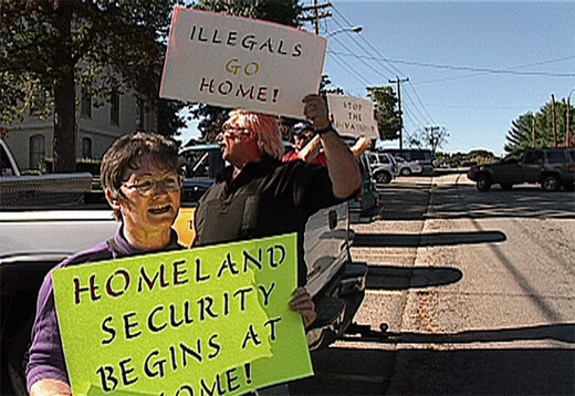 Counter-protesters during a rally for immigrants' rights and against racial profiling in Morristown, 2003, from Morristown: in the air and sun (2007).