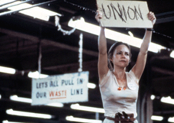In a film based on the Stevens campaign, Norma Rae (Sally Fields) holds up a sign to unionize, from Norma Rae, 1979. 