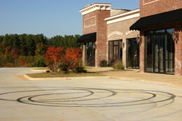 John Howard, Unoccupied commuter mall with stray business cards and ATV tracks, Henry County, Georgia, November 2008.