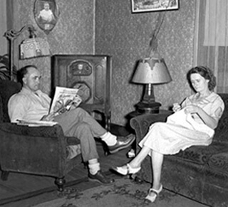 A couple listens to their radio, 1938