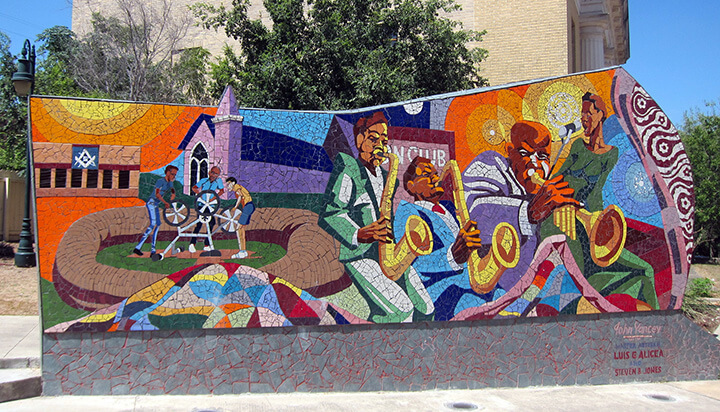 Detail of Rhapsody, a fifty-foot-long mosaic mural located in Urdy Plaza, Austin, Texas. Mural by John Yancy, master artisan Luis G. Alicea, and artist Stephen B. Jones, 2004. Photograph by Flickr user Wally Gobetz, August, 17, 2012 (CC BY-NC-ND 2.0).