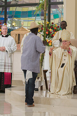 Archbishop Thomas Wenski receiving offertory gifts of fruits and native plants from parishioners, Notre Dame d'Haiti Catholic Church dedication service, Miami, Florida, February 1, 2015. Photo by Ana Rodriguez-Soto. Courtesy of the Archdiocese of Miami.