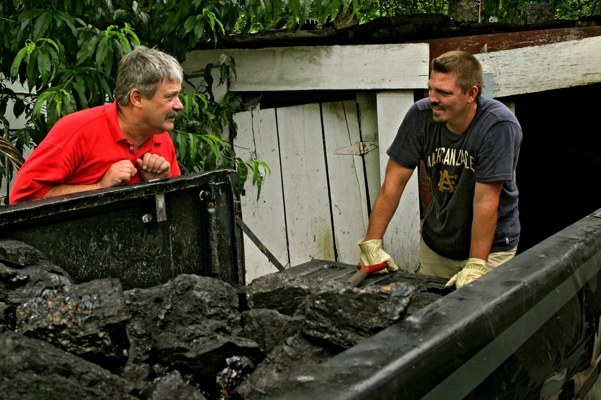 Letcher County Judge, Carroll Smith, visits with local resident loading house coal. Letcher County, KY, 2005.