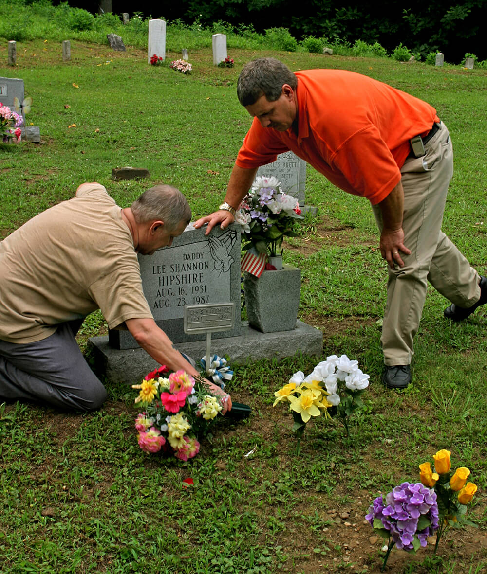 Sons attend the grave of their father, Lee Hipshire, a coal miner and black lung victim. Logan County, WV, 2005.