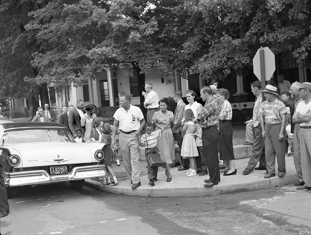 The parents of six-year-old Sinclair Lee, Jr., lead their son to Glenn Elementary, Nashville, TN, September 1957. © Nashville Public Library.​​