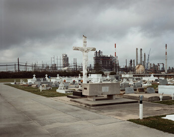 Richard Misrach, Holy Rosary Cemetery and Dow Chemical Corporation (Union Carbide Complex), Taft, Louisiana, 1998 from Petrochemical America, photographs by Richard Misrach, Ecological Atlas by Kate Orff (Aperture, 2012). © Richard Misrach, courtesy of Pace/MacGill Gallery, New York; Fraenkel Gallery, San Francisco; and Marc Selwyn Gallery, Los Angeles.