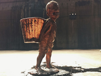 Child carrying basket inside Kara Walker's A Subtlety, Brooklyn, New York, June 15, 2014. Photograph by B. C. Lorio. Courtesy of B. C. Lorio.