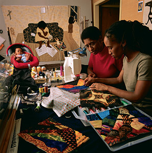 Gwen Magee at work with her daughter Kamili Magee Hemphill and Grandson Ellington Hemphill. Photo courtesy of Roland L. Freeman, 2014.