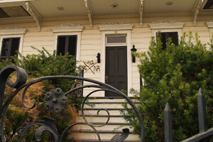 Step Up, Moss Street, Faubourg St. John, New Orleans, Louisiana, 2010. Photograph by Cynthia Scott. Even well groomed houses have kept the X, almost as a badge of courage. © Cynthia Scott.