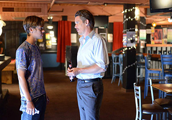 Mason Sr. (Ethan Hawke) and Mason Jr. share a moment inside an empty rock club near the end of the film, 2014. © IFC Films.