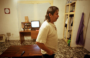 At home after a long day of work, Scott County, Mississippi, 2004. Photograph by John Fiege. Courtesy of John Fiege.