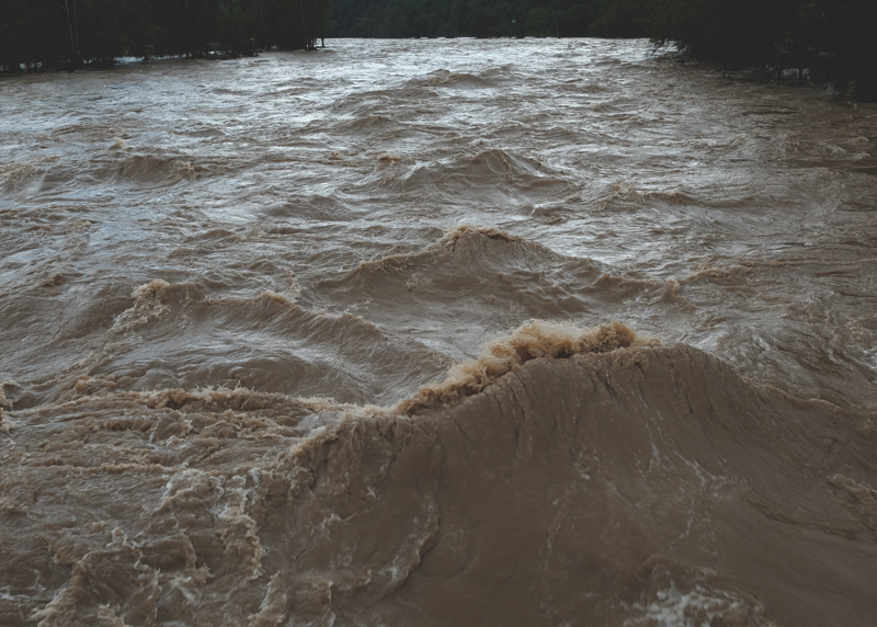 Raging French Broad River at flood stage during Hurricane Helene near Marshall, North Carolina.