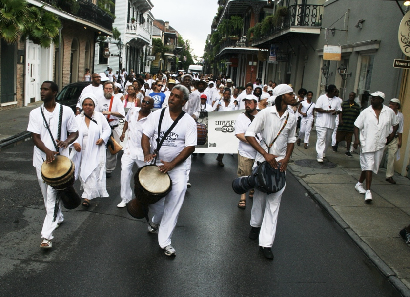 Parade of white costumed people led by three drummers at Maafa Ceremony 2010.